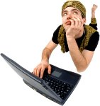 Woman thinking behind a laptop